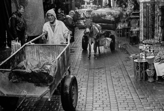 Donkeys pull and old men push as the hive of activity among the covered streets of the souks carries on for the workers.